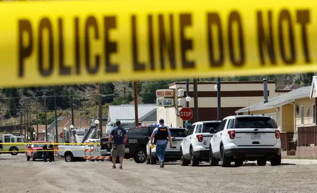 Police and other emergency personnel are seen after a reported shooting in Anaconda, Mont., Friday, Aug. 1, 2025. (Joseph Scheller/The Montana Standard via AP)