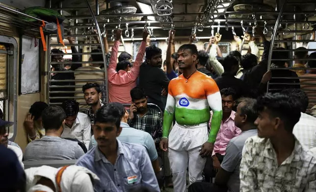 Rickshaw driver Govinda Prajapati, painted his body in colours of Indian flag, celebrates Independence day while travelling in a local train at Chhatrapati Shivaji Maharaj Terminus in Mumbai, India, Friday, Aug. 15, 2025. (AP Photo/Rajanish Kakade)