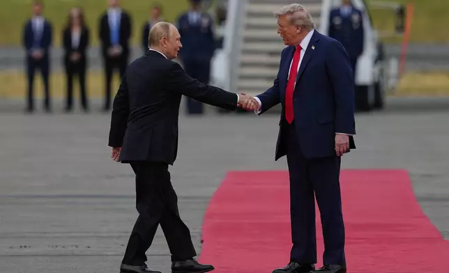 President Donald Trump greets Russia's President Vladimir Putin Friday, Aug. 15, 2025, at Joint Base Elmendorf-Richardson, Alaska. (AP Photo/Julia Demaree Nikhinson)
