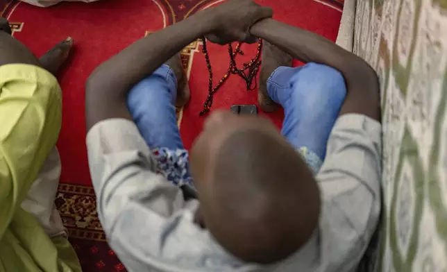 Worshippers listen to Imam Ibrahima Diane, advocate for an end to gender-based violence and practices like female genital mutilation, deliver his sermon at the Great Mosque of Nietty Mbar in Thiaroye, a suburb of Dakar, Senegal, Friday, July 4, 2025.(AP Photo/Sylvain Cherkaoui)