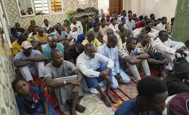 Worshippers listen to Imam Ibrahima Diane, advocate for gender equality and an end to harmful practices like FGM and gender-based violence, deliver his sermon at the Great Mosque of Nietty Mbar in Thiaroye, a suburb of Dakar, Senegal, Friday, July 4, 2025.(AP Photo/Sylvain Cherkaoui)