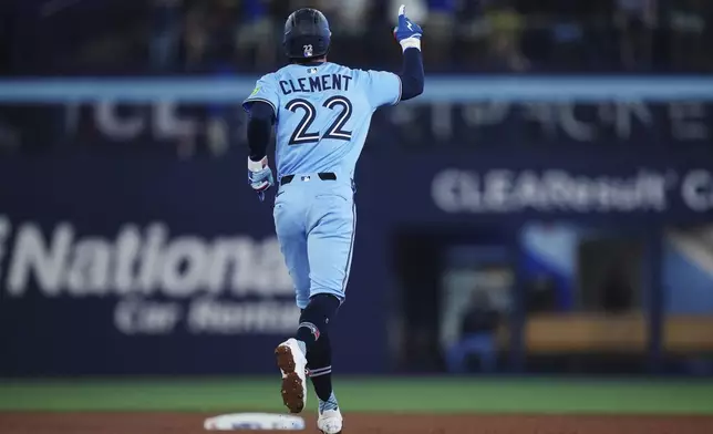 Toronto Blue Jays' Ernie Clement celebrates his three-run home run against the Chicago Cubs during fourth inning MLB baseball action in Toronto on Tuesday, August 12, 2025. (Nathan Denette/The Canadian Press via AP)