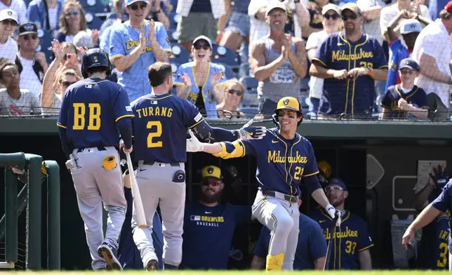 Milwaukee Brewers' Brice Turang (2) celebrates his two-run home run with Christian Yelich, right, during the seventh inning of a baseball game against the Washington Nationals, Sunday, Aug. 3, 2025, in Washington. (AP Photo/Nick Wass)