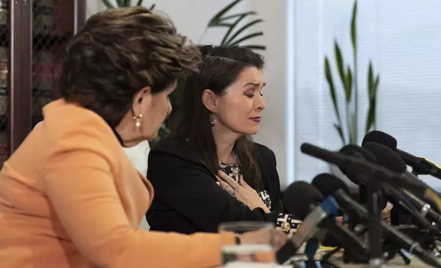 Alicia Arden, a woman who accused Jeffrey Epstein of sexual battery in 1997, gets emotional while reading her statement beside her attorney Gloria Allred, foreground, during a news conference in Los Angeles, Wednesday, Aug. 6, 2025. (AP Photo/Jae C. Hong)