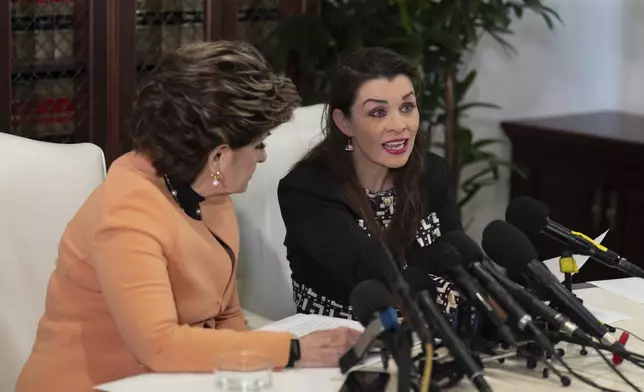 Alicia Arden, who accused Jeffrey Epstein of sexual battery in 1997, reads a statement alongside her attorney, Gloria Allred, during a news conference in Los Angeles Wednesday, Aug. 6, 2025. (AP Photo/Jae C. Hong)