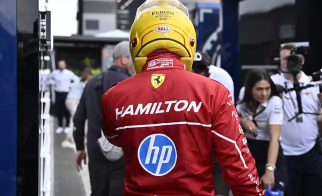 Ferrari driver Lewis Hamilton of Britain walks back to his pits after failing to complete during the qualifying session for the Hungarian Formula One Grand Prix at the Hungaroring racetrack in Mogyorod, Hungary, Saturday, Aug. 2, 2025. (AP Photo/Denes Erdos)