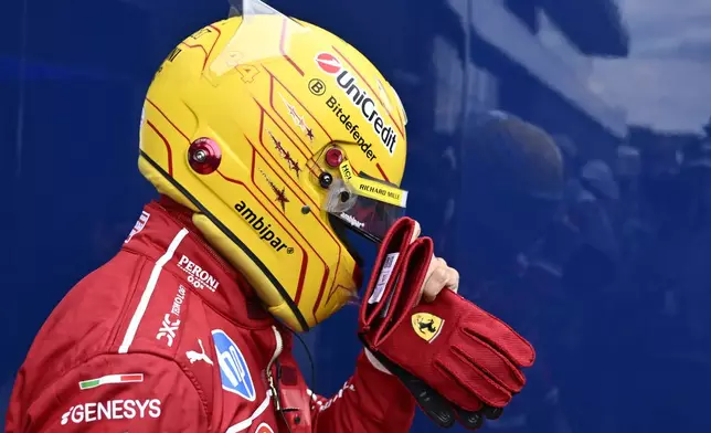Ferrari driver Lewis Hamilton of Britain walks back to his pits after failing to complete during the qualifying session for the Hungarian Formula One Grand Prix at the Hungaroring racetrack in Mogyorod, Hungary, Saturday, Aug. 2, 2025. (AP Photo/Denes Erdos)