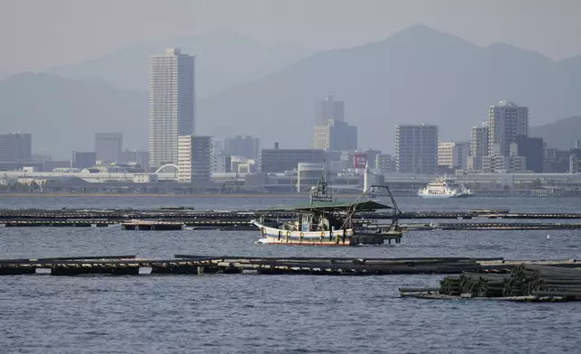 The cityscape of Hiroshima as seen from Ninoshima, an island where thousands of the dead and dying were brought after the first atomic bomb detonated 80 years ago, western Japan, Monday, July 7, 2025. (AP Photo/Eugene Hoshiko)