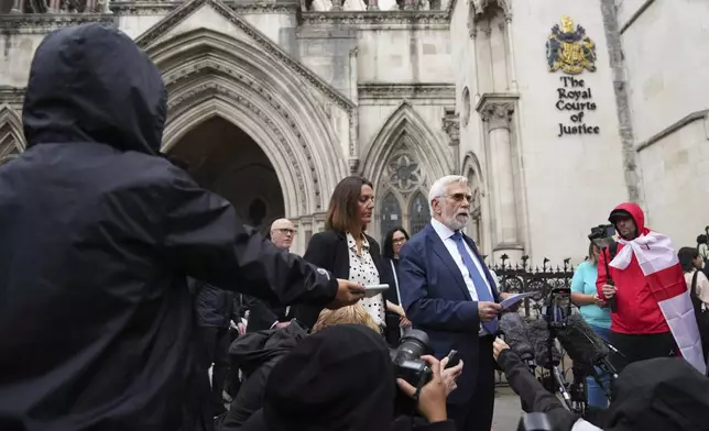 Ken Williamson, Councillor of Epping Forest District Council, center, speaks to press after the judgment due in Home Office and hotel owner's appeal bids against Epping asylum seeker ruling, at The Royal Courts Of Justice in London, Friday, Aug. 29, 2025. (AP Photo/ Joanna Chan)