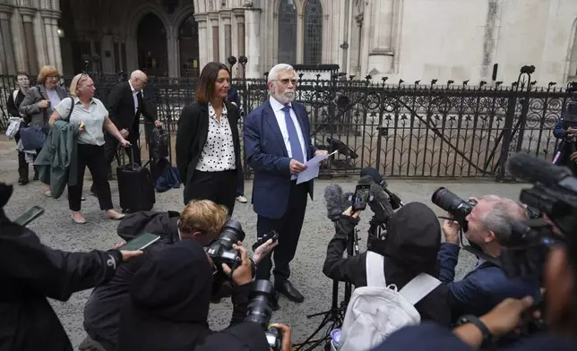 Ken Williamson, Councillor of Epping Forest District Council, front, speaks to press after the judgment due in Home Office and hotel owner's appeal bids against Epping asylum seeker ruling, at The Royal Courts Of Justice in London, Friday, Aug. 29, 2025. (AP Photo/ Joanna Chan)
