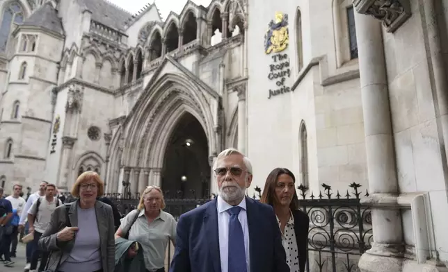 Ken Williamson, Councillor of Epping Forest District Council, second right, speaks to press after the judgment due in Home Office and hotel owner's appeal bids against Epping asylum seeker ruling, at The Royal Courts Of Justice in London, Friday, Aug. 29, 2025. (AP Photo/ Joanna Chan)
