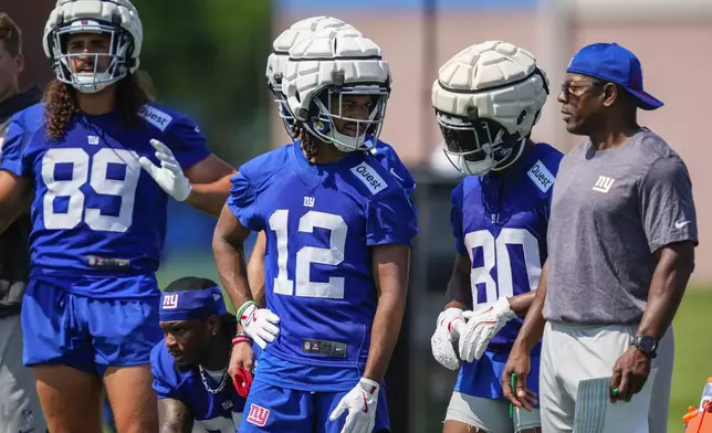FILE - New York Giants wide receiver Jordan Bly (12) and New York Giants wide receiver Montrell Washington (80) speak during a practice at the team's NFL football training camp in East Rutherford, N.J., July 24, 2025. (AP Photo/Yuki Iwamura, file)