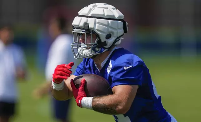 New York Giants running back Cam Skattebo (44) runs with the ball during practice at the team's NFL football training camp in East Rutherford, N.J., Thursday, July 24, 2025. (AP Photo/Yuki Iwamura)