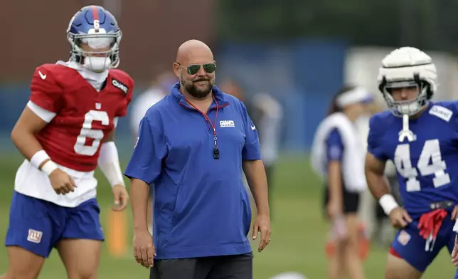 New York Giants head coach Brian Daboll looks on between quarterback Jaxson Dart (6) running back Cam Skattebo (44) during Back Together Weekend at the team's NFL football training camp, Sunday, July 27, 2025, in East Rutherford, N.J. (AP Photo/Adam Hunger)