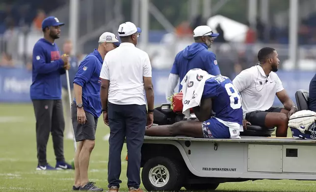 New York Giants wide receiver Bryce Ford-Wheaton (88) reacts to being carted off during Back Together Weekend at the team's NFL football training camp, Sunday, July 27, 2025, in East Rutherford, N.J. (AP Photo/Adam Hunger)