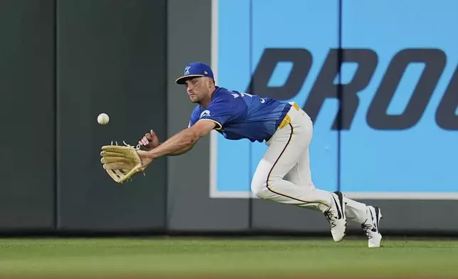 Minnesota Twins right fielder Matt Wallner tries to catch a single hit by Kansas City Royals' John Rave during the fifth inning of a baseball game Friday, Aug. 8, 2025, in Minneapolis. (AP Photo/Abbie Parr)