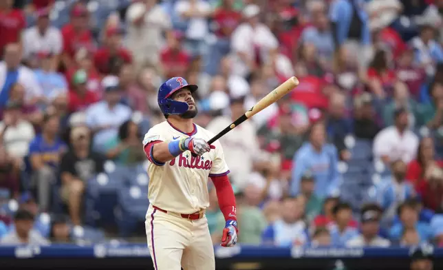 Philadelphia Phillies' Kyle Schwarber watches after hitting a two-run home run against Seattle Mariners pitcher Sauryn Lao during the eighth inning of a baseball game Wednesday, Aug. 20, 2025, in Philadelphia. (AP Photo/Matt Slocum)