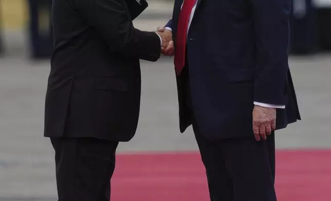 President Donald Trump greets Russia's President Vladimir Putin on the tarmac at Joint Base Elmendorf-Richardson in Anchorage, Alaska, Aug. 15, 2025. (AP Photo/Julia Demaree Nikhinson)