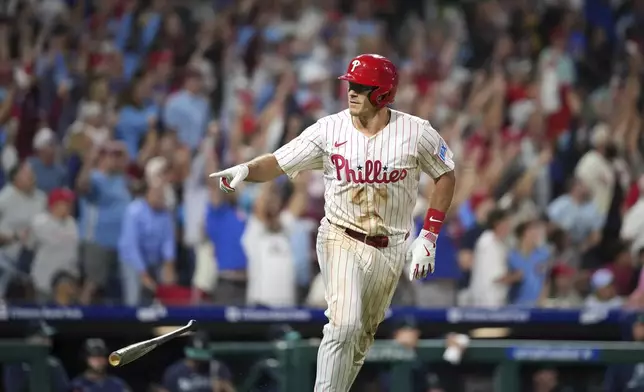 Philadelphia Phillies' J.T. Realmuto reacts after hitting a two-run home run against Seattle Mariners pitcher Matt Brash during the eighth inning of a baseball game Tuesday, Aug. 19, 2025, in Philadelphia. (AP Photo/Matt Slocum)