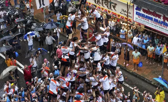 Devotees form a human pyramid as part of celebrations to mark Janmashtami festival in Mumbai, India, Saturday, Aug. 16, 2025. (AP Photo/Rajanish Kakade)