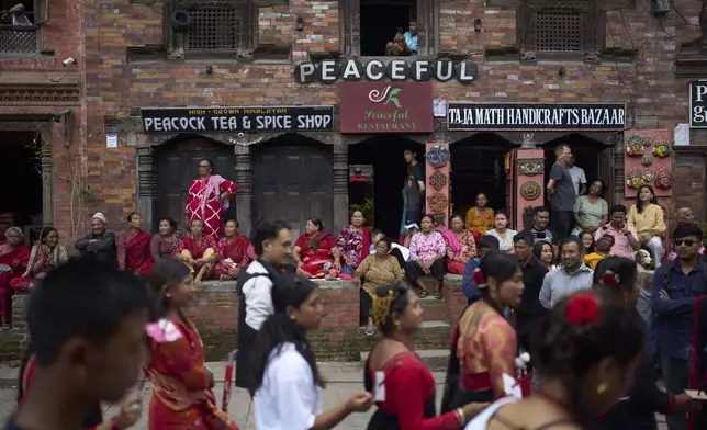 People watch a parade celebrating the birthday of Lord Krishna on Krishna Janmashtami in Bhaktapur,Nepal, Saturday, Aug. 16, 2025. (AP Photo/Niranjan Shrestha)