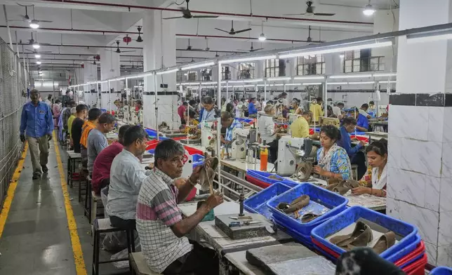 Workers in a manufacturing unit make leather footwear in Agra, India, Monday, Aug. 25, 2025. (AP Photo/Manish Swarup)