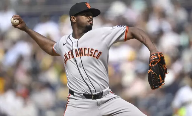 San Francisco Giants relief pitcher Joel Peguero works against a San Diego Padres batter during the seventh inning of a baseball game Thursday, Aug. 21, 2025, in San Diego. (AP Photo/Orlando Ramirez)