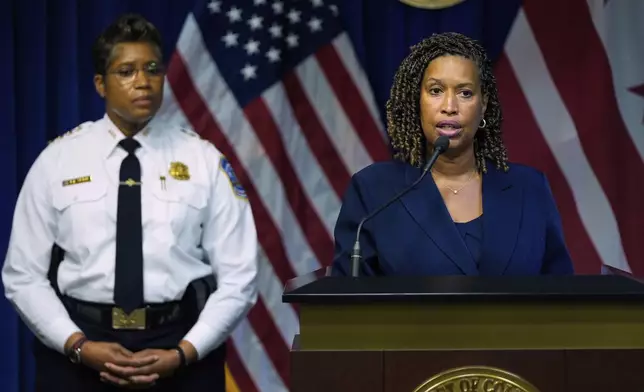 Washington Mayor Muriel Bowser speaks as Metropolitan Police Department Chief Pamela Smith listens during a news conference on President Donald Trump's plan to place Washington police under federal control and deploy National guard troops to Washington, Monday, Aug. 11, 2025, in Washington. (AP Photo/Julia Demaree Nikhinson)