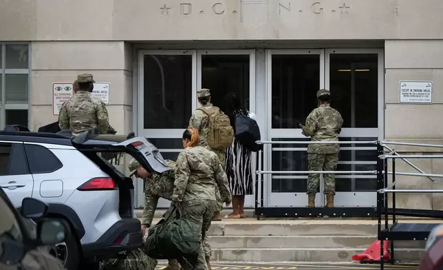 National Guard troops arrive at the District of Columbia National Guard Headquarters, Tuesday, Aug. 12, 2025, in Washington. (AP Photo/Julia Demaree Nikhinson)