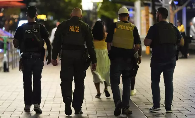 Federal law enforcement officers patrol The Wharf, Monday, Aug. 11, 2025, in Washington. (AP Photo/Julia Demaree Nikhinson)