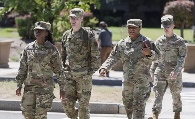 Troops depart the District of Columbia National Guard Headquarters as President Donald Trump implements his order to use federal law enforcement and the National Guard to expel homeless people and rid the nation's capital of violent crime, in Washington, Tuesday, Aug. 12, 2025. (AP Photo/J. Scott Applewhite)