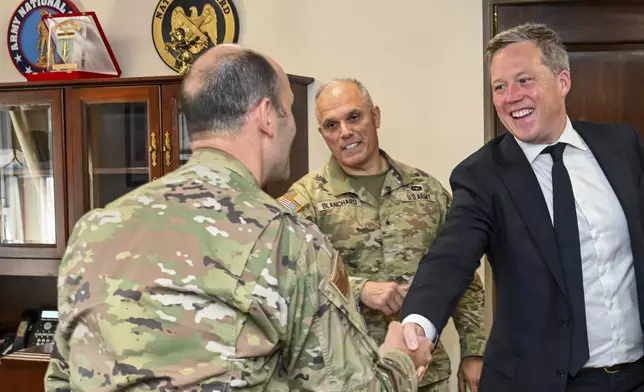In this image provided by the U.S. Army National Guard, Secretary of the Army Dan Driscoll shakes hands with Air Force Brig. Gen. Matthew McDonough, commander of the 113th wing, left, during a visit with soldiers and airmen from the District of Columbia National Guard at the D.C. National Guard Armory in Washington, Tuesday, Aug. 12, 2025. (Sgt. 1st Class Christy L. Sherman/U.S. Army National Guard via AP)