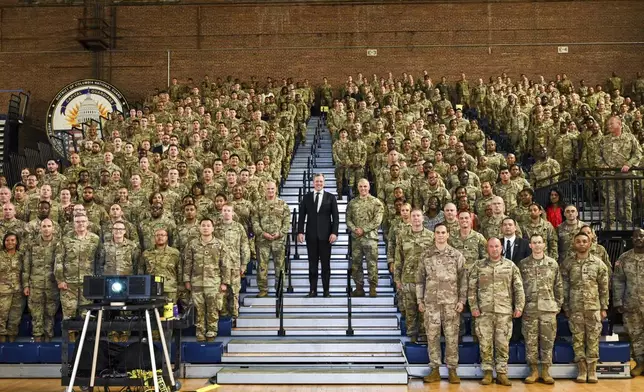 In this image provided by the U.S. Army National Guard, Secretary of the Army Dan Driscoll poses with soldiers and airmen from the District of Columbia National Guard at the D.C. National Guard Armory in Washington, Tuesday, Aug. 12, 2025. (Sgt. 1st Class Christy L. Sherman/U.S. Army National Guard via AP)