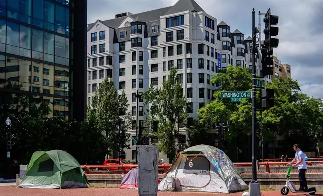 Tents are set up on a sidewalk near George Washington University, Monday, Aug. 11, 2025, in Washington. (AP Photo/Julia Demaree Nikhinson)