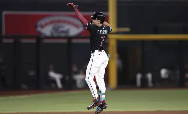 Arizona Diamondbacks' Corbin Carroll celebrates after his two-run home run against the Colorado Rockies during the fifth inning of a baseball game Saturday, Aug. 9, 2025, in Phoenix. (AP Photo/Chris Coduto)