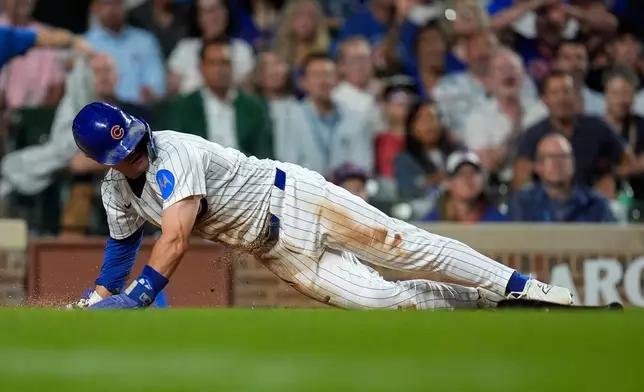Chicago Cubs' Matt Shaw (6) scores on a single from Michael Busch (29) during the sixth inning of the second baseball game of a split doubleheader against the Milwaukee Brewers, Tuesday, Aug. 19, 2025, in Chicago. (AP Photo/Erin Hooley)
