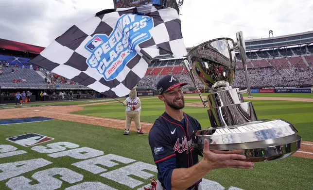 Atlanta Braves outfielder Eli White holds the trophy after their win against the Cincinnati Reds I the MLB Speedway Classic baseball game at Bristol Motor Speedway in Bristol, Tenn., Sunday, Aug. 3, 2025. Play was resumed today after yesterday's weather delay. (AP Photo/George Walker IV)