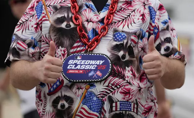A fan poses before the MLB Speedway Classic baseball game at Bristol Motor Speedway in Bristol, Tenn., Sunday, Aug. 3, 2025. Play was resumed today after yesterday's weather delay. (AP Photo/George Walker IV)