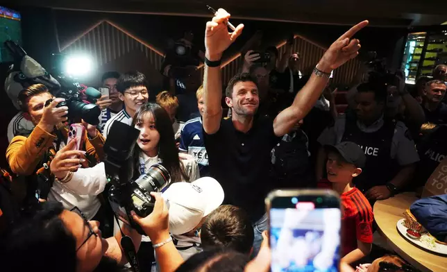 New Vancouver Whitecaps player Thomas Muller spends time with fans as he arrives from Germany at Vancouver International Airport in Richmond, British Columbia, Wednesday, Aug. 13, 2025. (Darryl Dyck/The Canadian Press via AP)