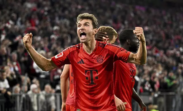 FILE - Munich's Thomas Muller celebrates a 1-0 win in a German Bundesliga soccer match between FC Bayern Munich and VfB Stuttgart, in Munich, Germany, Saturday, Oct. 19, 2024. (Tom Weller/dpa via AP, File)
