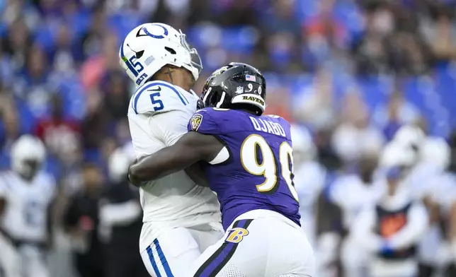 Indianapolis Colts quarterback Anthony Richardson Sr. (5) is sacked by Baltimore Ravens linebacker David Ojabo (90) during the firs half of an NFL preseason football game Thursday, Aug. 7, 2025, in Baltimore. (AP Photo/Nick Wass)