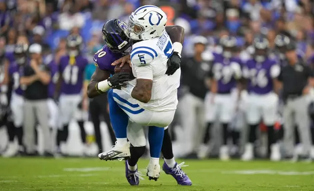 Indianapolis Colts quarterback Anthony Richardson Sr. (5) is sacked by Baltimore Ravens linebacker David Ojabo (90) during the firs half of an NFL preseason football game Thursday, Aug. 7, 2025, in Baltimore. (AP Photo/Alex Brandon)