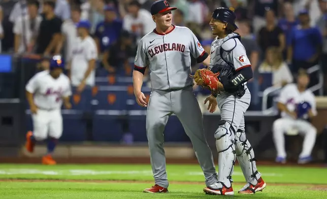 Cleveland Guardians pitcher Nic Enright, left, and catcher Bo Naylor, right, celebrate after their win in a baseball game against the New York Mets at Citi Field in New York, Monday, Aug. 4, 2025. (Gordon Donovan via AP)