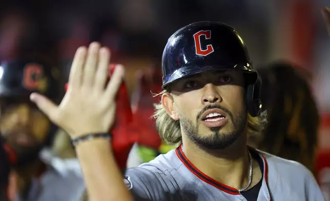 Cleveland Guardians' Gabriel Arias is congratulated in the dugout after hitting a home run during the sixth inning of a baseball game against the New York Mets at Citi Field in New York, Monday, Aug. 4, 2025. (Gordon Donovan via AP)