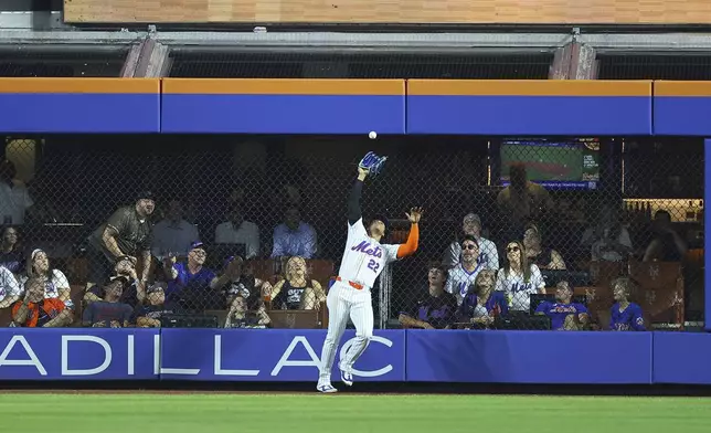 New York Mets right fielder Juan Soto (22) makes catch against the wall during the eighth inning of a baseball game against the Cleveland Guardians at Citi Field in New York, Monday, Aug. 4, 2025. (Gordon Donovan via AP)