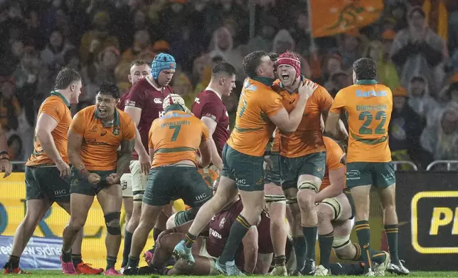 Australia players celebrate after Tate McDermott scored his side's third try during the third and final rugby union test between the Lions and the Wallabies in Sydney, Australia, Saturday, Aug. 2, 2025. (AP Photo/Mark Baker)
