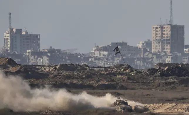 An Israeli armored vehicle moves in an area in the Gaza Strip, as seen from southern Israel, Friday, Aug. 29, 2025. (AP Photo/Maya Levin)