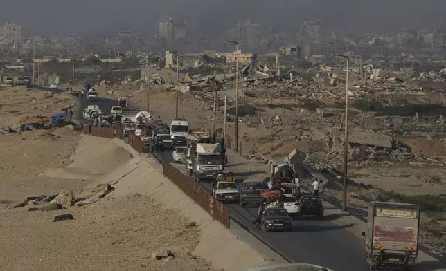 Displaced Palestinians fleeing northern Gaza Strip move with their belongings along the Sea Road, near Wadi Gaza, Saturday, Aug. 30, 2025. (AP Photo/Abdel Kareem Hana)