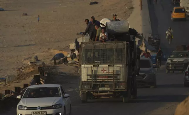 Displaced Palestinians fleeing northern Gaza Strip move with their belongings along the Sea Road, near Wadi Gaza, Saturday, Aug. 30, 2025. (AP Photo/Abdel Kareem Hana)