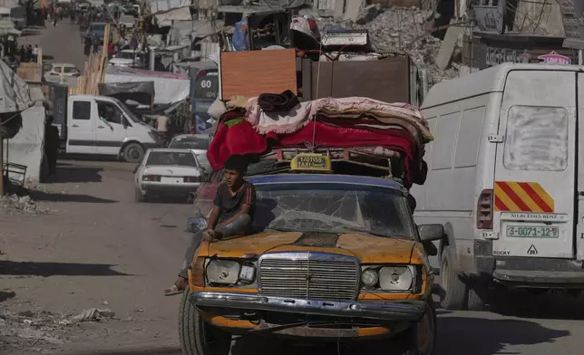 Displaced Palestinians fleeing northern Gaza Strip move with their belongings on a street in Gaza City, Thursday, Aug. 28, 2025. (AP Photo/Abdel Kareem Hana)